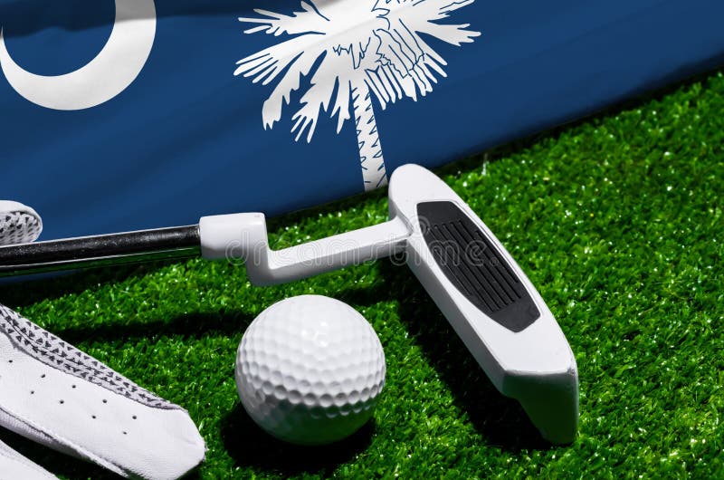 Golf ball and club with flag of South Carolina on green grass. Golf championship in South Carolina