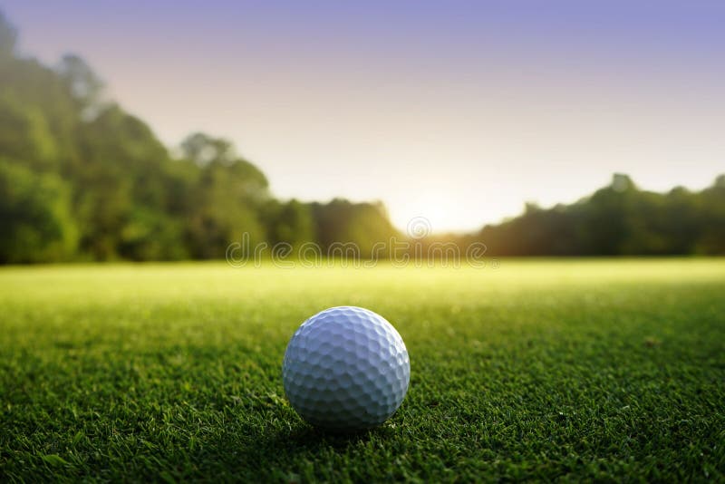 Golf ball on green in beautiful golf course at sunset background stock photography Golf ball on green in beautiful golf course at sunset background stock photography