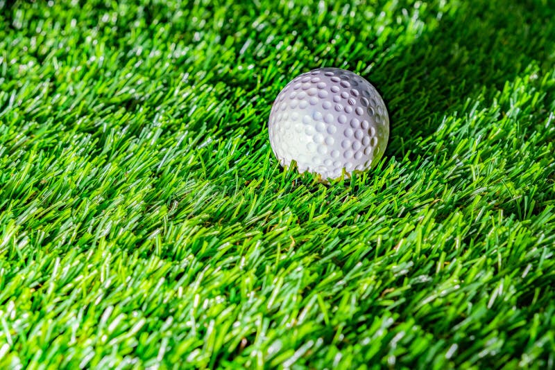 Golf ball on green grass stock image. Image of light 163875223