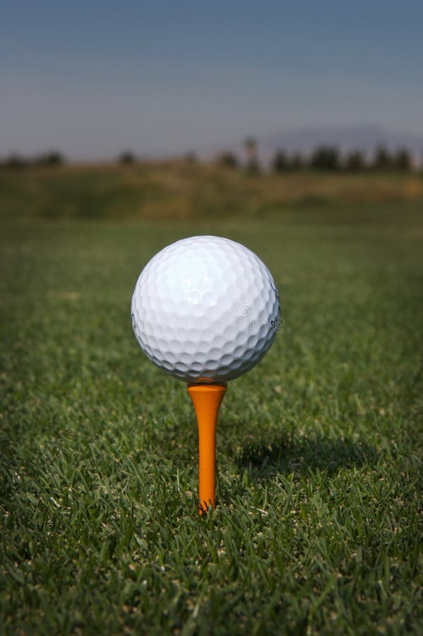 Golf ball on a orange tee