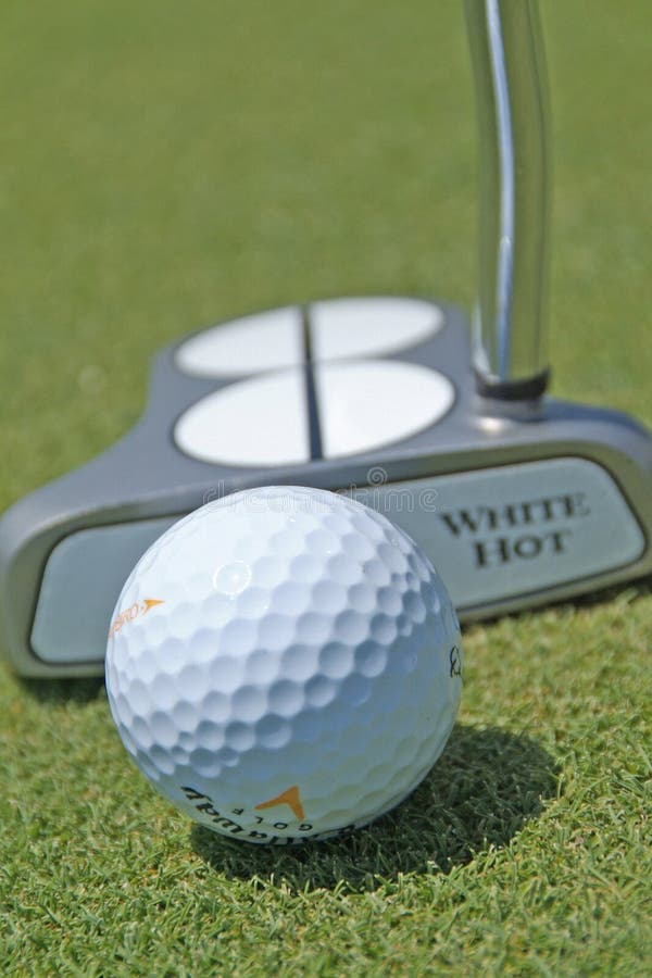 Golf ball and putter editorial image. Image of putt 189771255