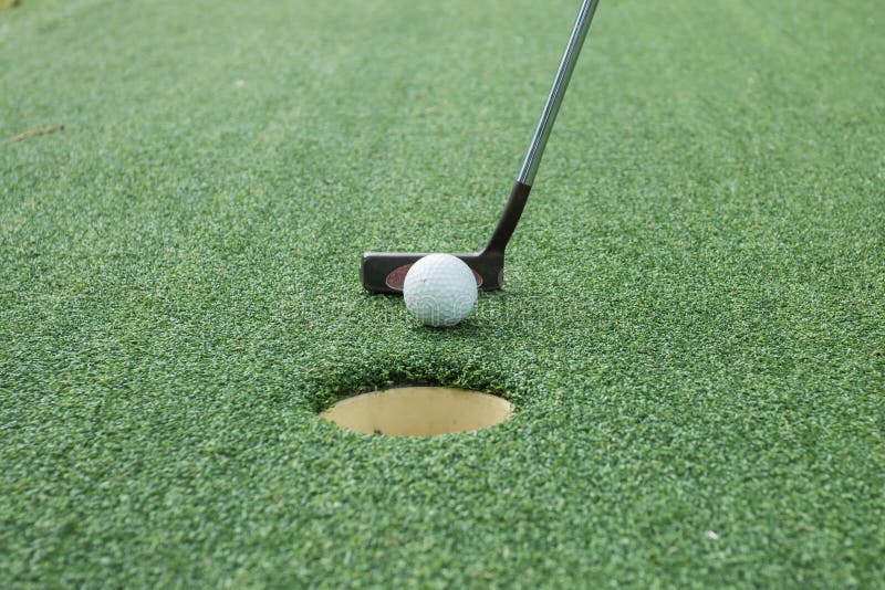 Golf ball and tee on green course