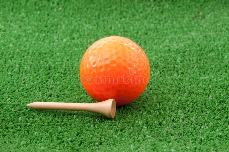 Golf Ball and a Tee on Green Grass Stock Image Image of orange, golf