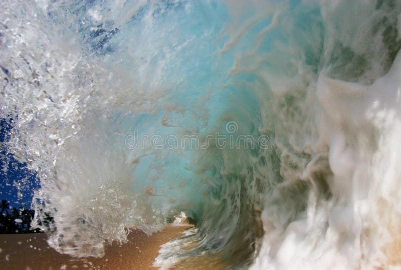 A wave breaking on the shore at Keiki Beach on the North Shore of Oahu, Hawaii. A wave breaking on the shore at Keiki Beach on the North Shore of Oahu, Hawaii.