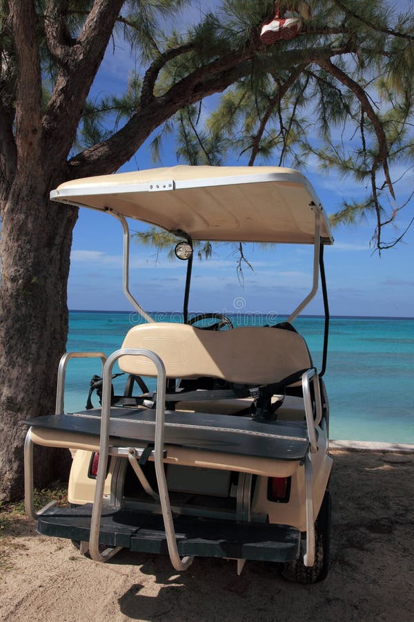 Golf cart on beach at tropical island resort hotel