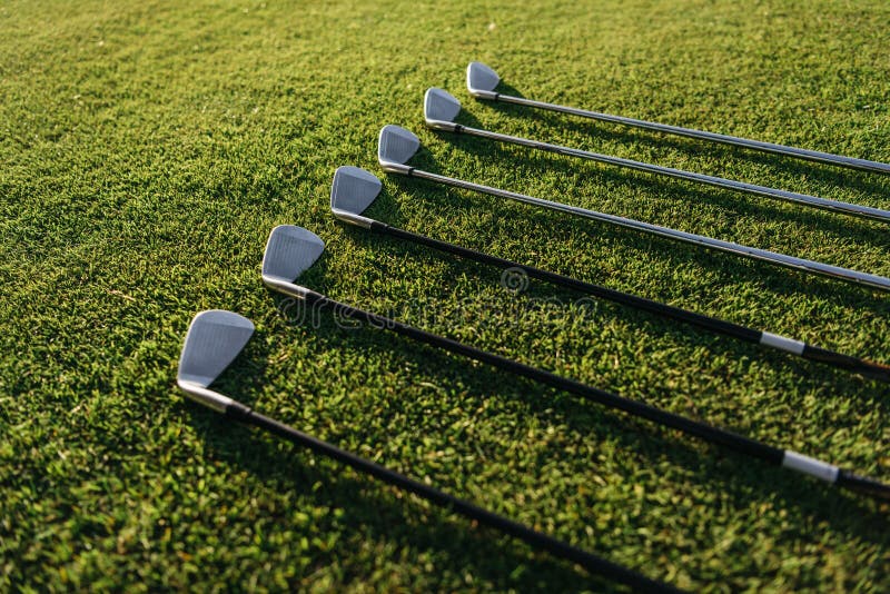 Golf Clubs Arranged on the Green Grassy Field Stock Photo Image of
