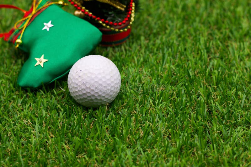 Golf ball with Christmas ornament are on green grass. Golf ball with Christmas ornament are on green grass