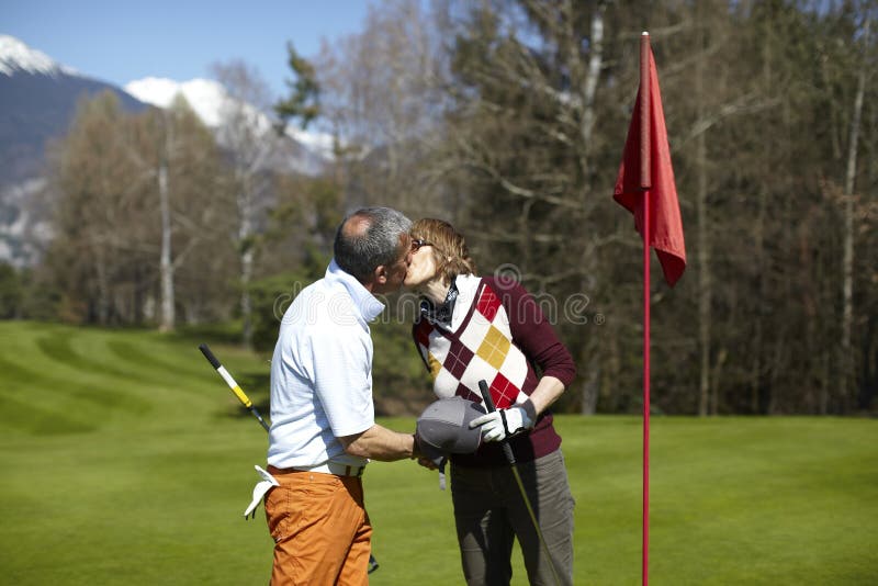 Golf couple kissing on a golf course