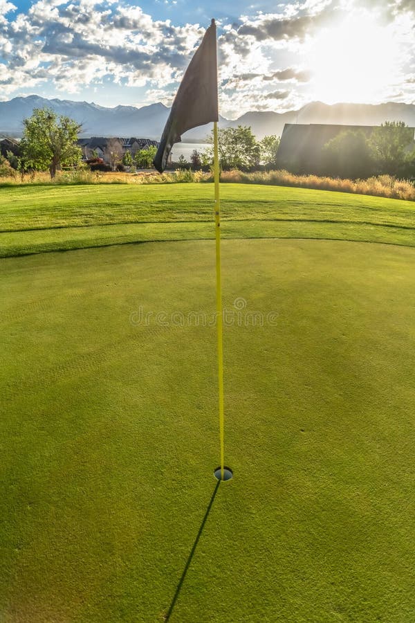 Golf Course with Focus on a Yellow Flagstick with a Black Cloth on the Tip Stock Image Image