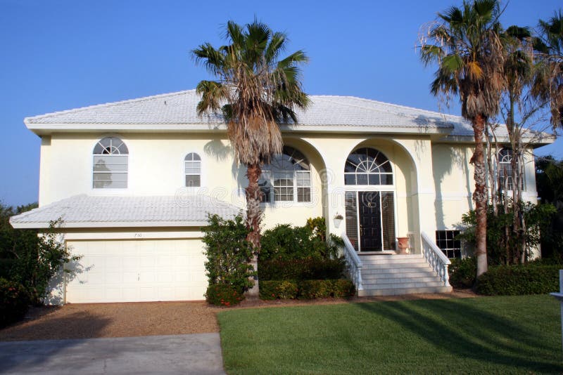 An expensive mansion on Sanible Island, Florida has a backyard to the country club golf course. An expensive mansion on Sanible Island, Florida has a backyard to the country club golf course