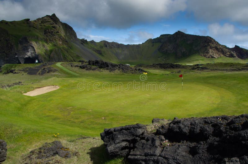 Golf course under mountains