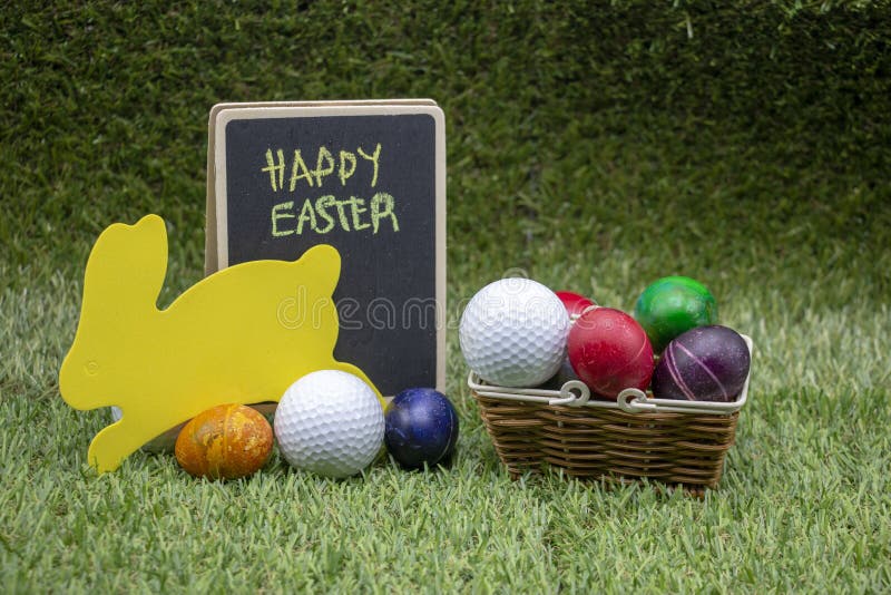 Golf Easter with Golf Ball and Easter Eggs on Green Grass Stock Photo