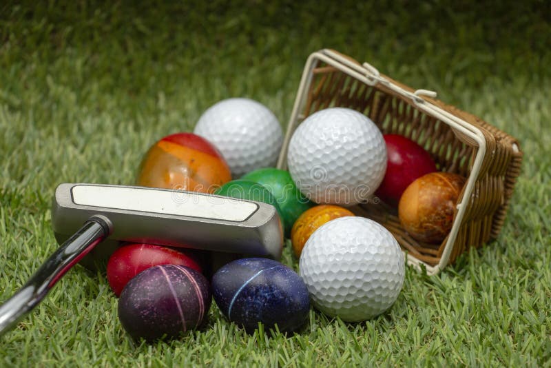 Golf Easter with Golf Ball and Easter Eggs on Green Grass Stock Photo