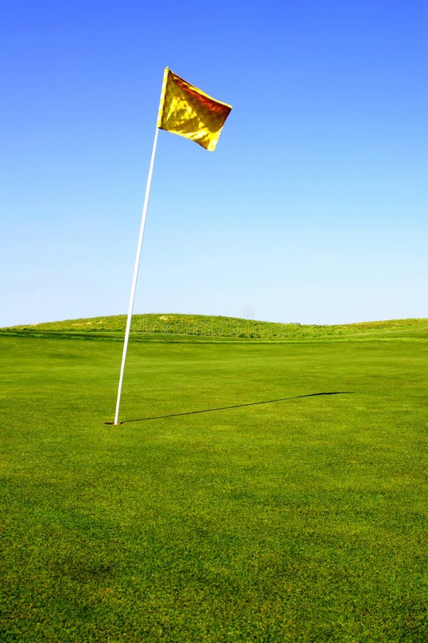 A pristine golf green and flag in the morning. A pristine golf green and flag in the morning.