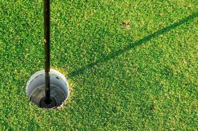 Golf hole with flag embroidered on the lawn. Day game drive stock images, royalty-free photos and pictures
