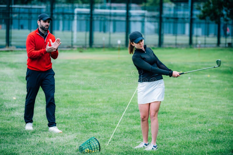 Golf Instructor Working with Young Woman on Swing Improvement Stock Photo Image of golf, fancy