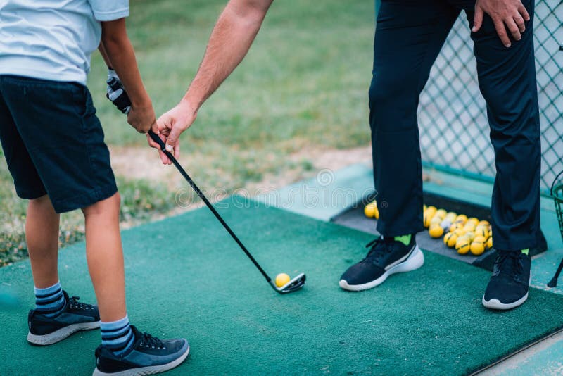 Golf Lessons. Golf Instructor Giving Game Lesson To a Young Boy Stock