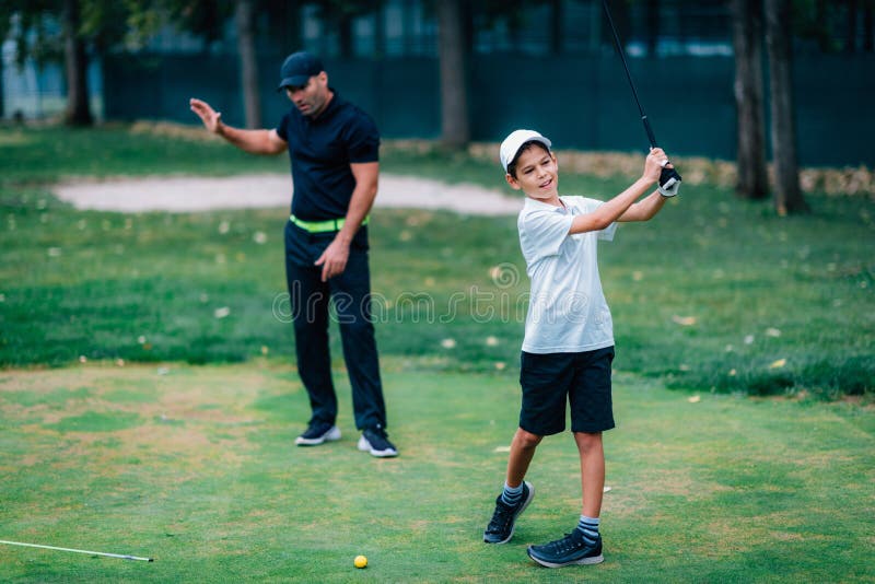 Golf â€“ Personal Training. Golf Instructor Teaching Young Boy How To