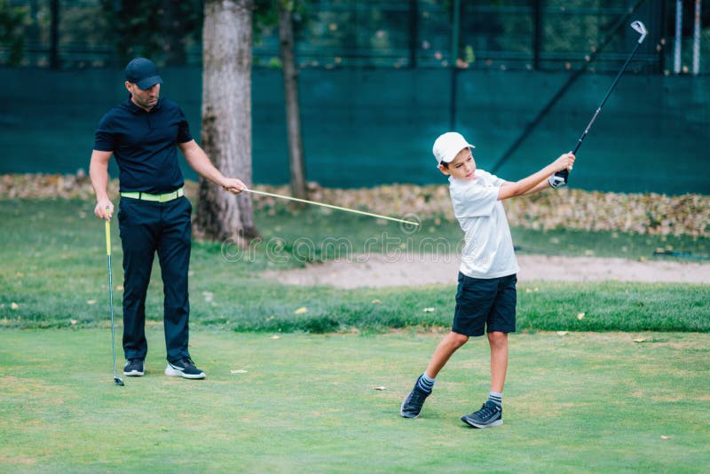Golf â€“ Personal Training. Golf Instructor Teaching Young Boy How To