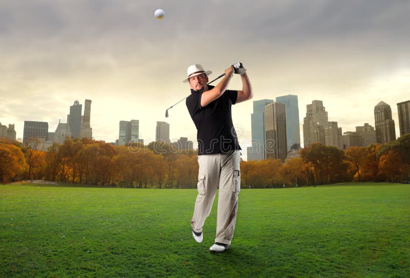 Golf player shooting with modern city on the background