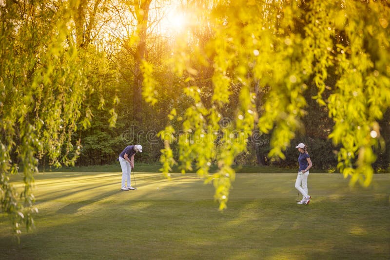 Golf player couple on green.