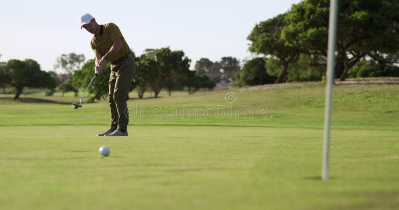Golf player hitting the ball with his club