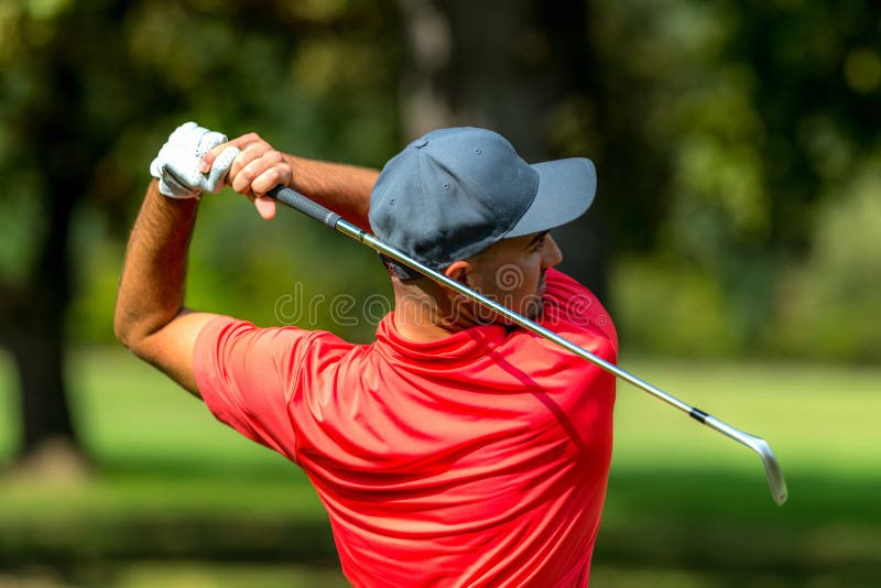 Golf Swing Rear View. Professional Golfer Finishing a Golf Swing Stock