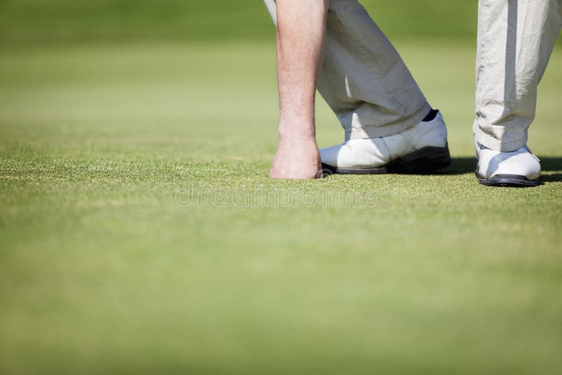 Golfer picking up ball. stock image. Image of free, play 19548983
