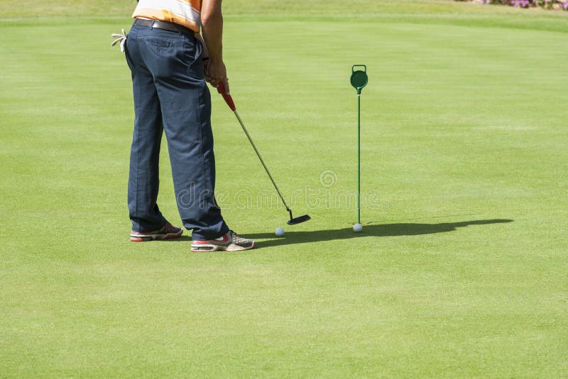 Golfer practising putting