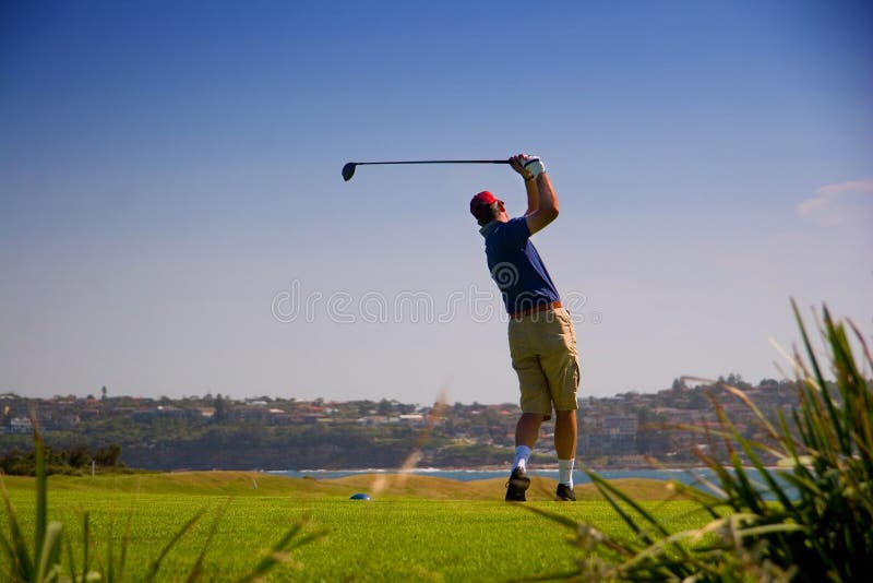 Golfer teeing off at Long Reef Point, North Sydney, New South Wales (NSW), Australia
