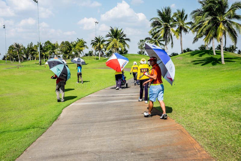 Golfers and Caddies Walking on the Path Editorial Photo Image of sport, grass 66680441