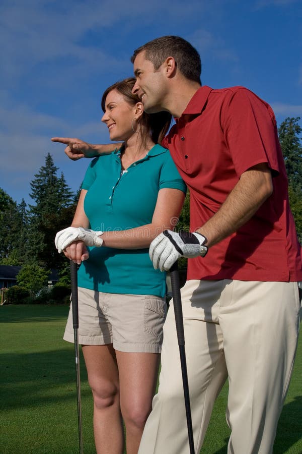 Golfers Look into Distance - Vertical