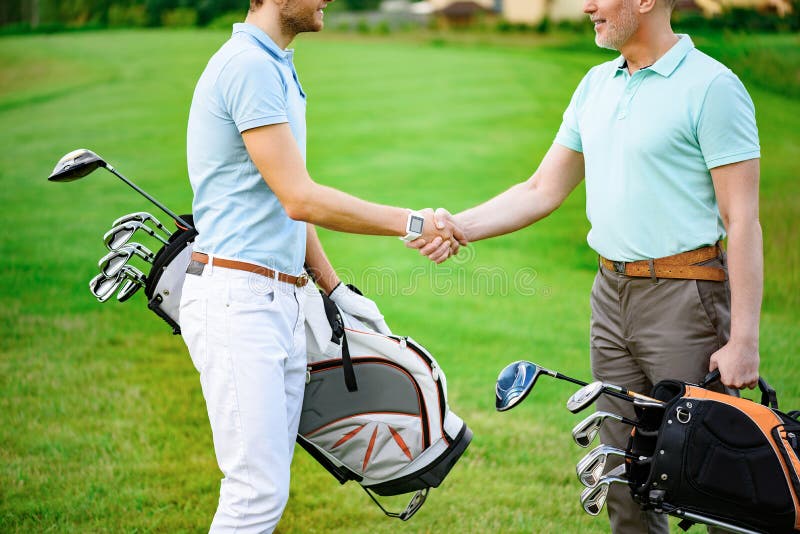 Golfers shake hands with each other