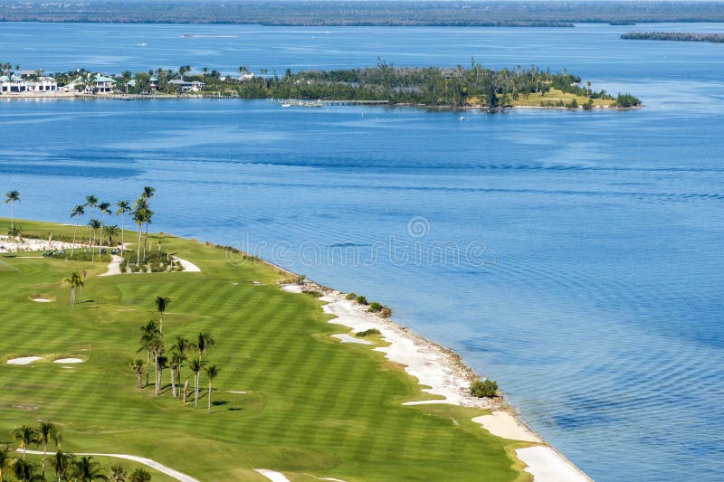 Waterfront golf course in Florida. Sports grounds with green grass in Boca Grande, small town on Gasparilla Island. Waterfront golf course in Florida. Sports grounds with green grass in Boca Grande, small town on Gasparilla Island.