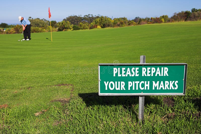 A golfer playing golf on a green. Shallow D.O.F - sign in focus, golfer out of focus. A golfer playing golf on a green. Shallow D.O.F - sign in focus, golfer out of focus.