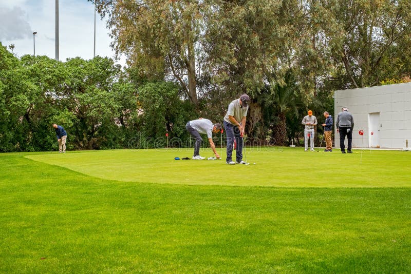 Golftrainer die met golfspeler bij het drijven van waaier werken stock afbeeldingen Golftrainer die met golfspeler bij het drijven van waaier werken stock afbeeldingen