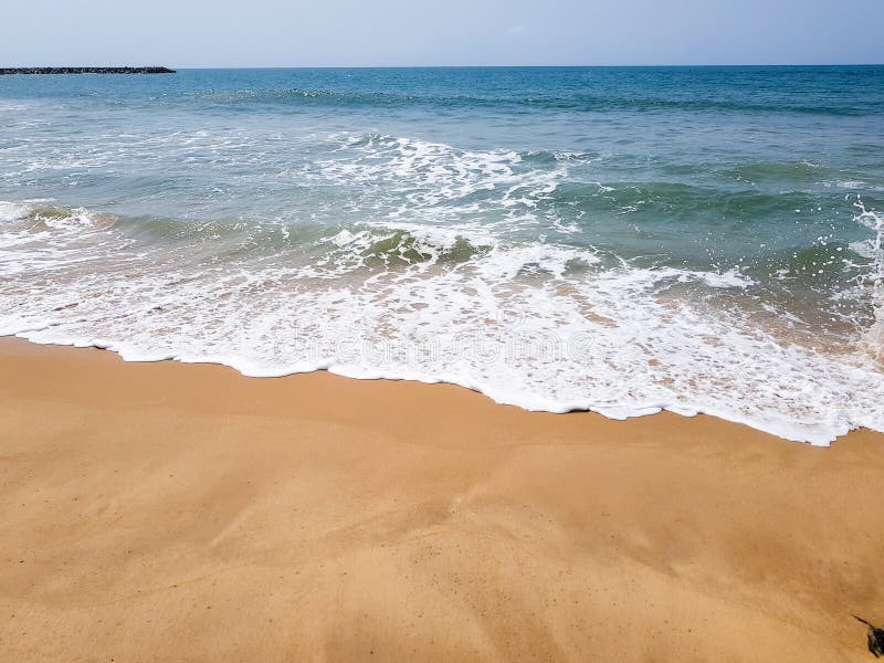 Golven die met wit schuim op een zandig strand breken De mooie mening van de waterkant van de Atlantische Oceaan royalty-vrije stock foto's Golven die met wit schuim op een zandig strand breken De mooie mening van de waterkant van de Atlantische Oceaan royalty-vrije stock foto's