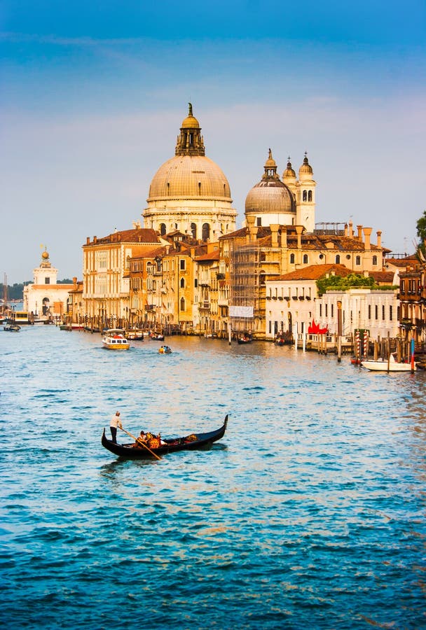 Gondola on Canal Grande with Basilica di Santa Maria della Salute at sunset, Venice, Italy