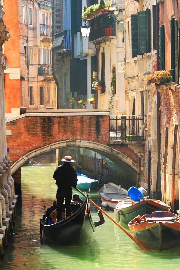 gondola on canal in venice, italy. stock photo - image of