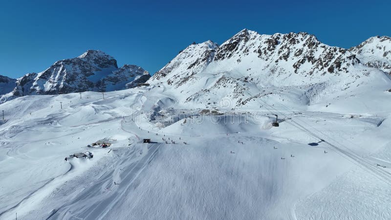 Gondola in the Engadin ski resort. Ski Lift Gondola Chairlift at Ski Resort St. Moritz on Snowy Mountain Slope, Top Aerial view stock footage