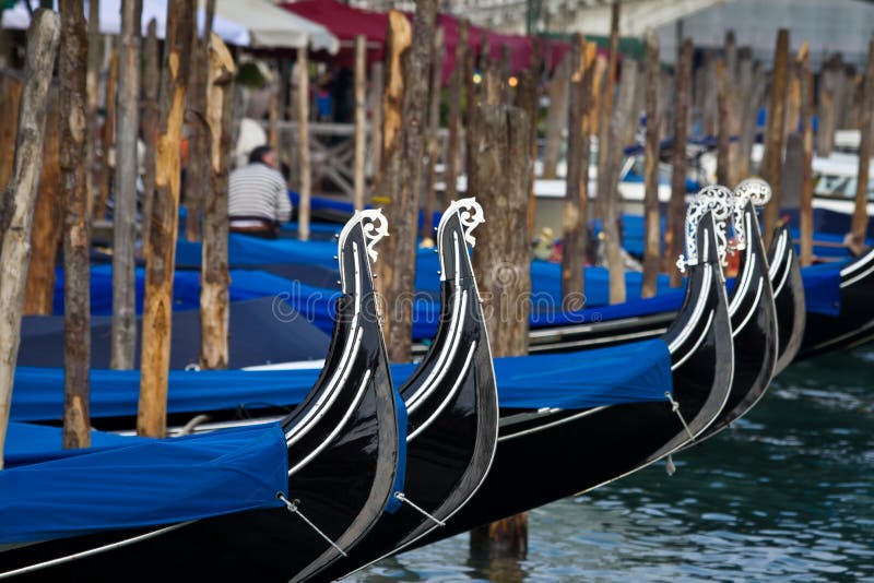 Venice gondolas moored at the pier in historic Italian city place on the water. Venice gondolas moored at the pier in historic Italian city place on the water