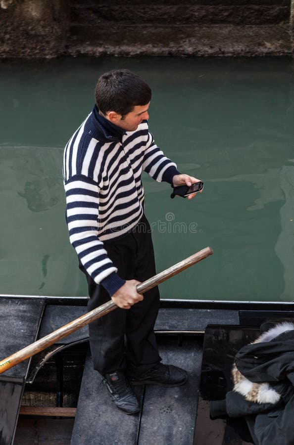 Gondolier Checking his Mobile Phone