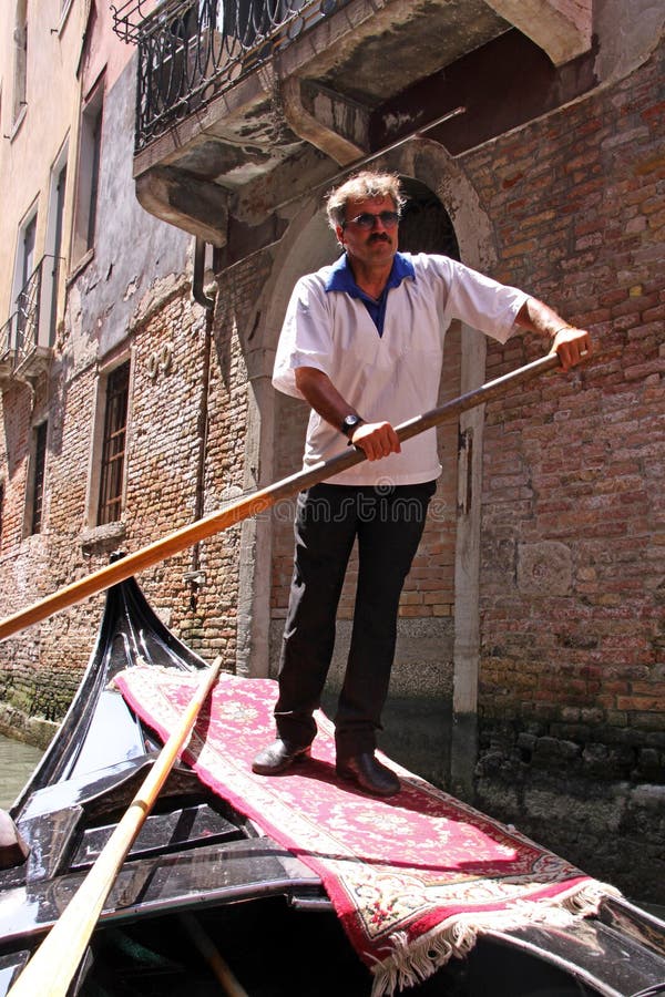 Gondolier in a gondola editorial photography. Image of venetian - 17956432