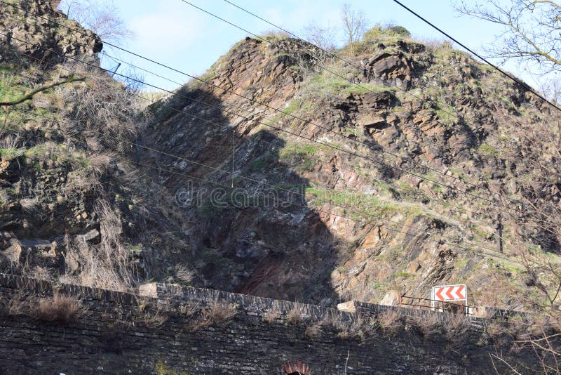 Mosel valley road near Lehmen during the winter flood with this narrow road between rough cliffs on the Eifel side being a main connection in Moselle valley. Mosel valley road near Lehmen during the winter flood with this narrow road between rough cliffs on the Eifel side being a main connection in Moselle valley.