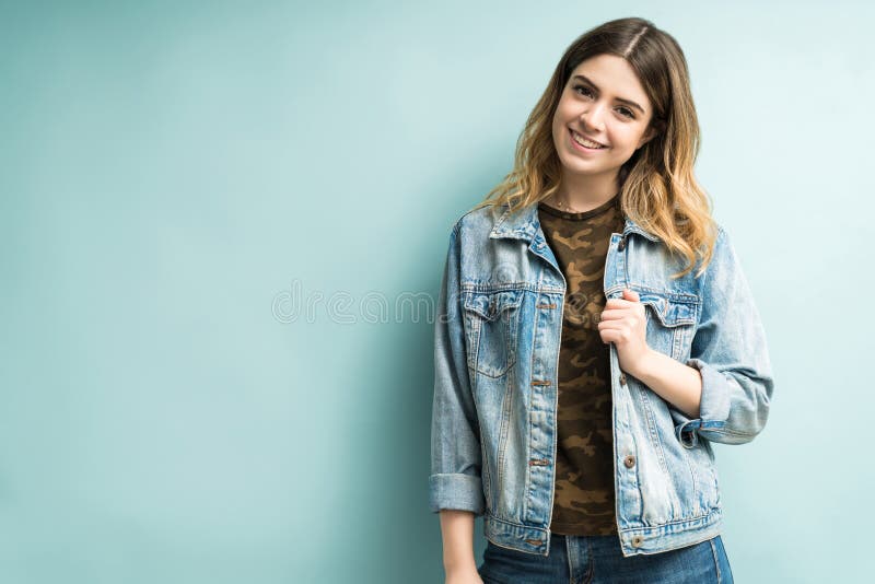 good looking female wearing denim jacket posing studio portrait stylish smiling woman wearing denim jacket standing against 167567940