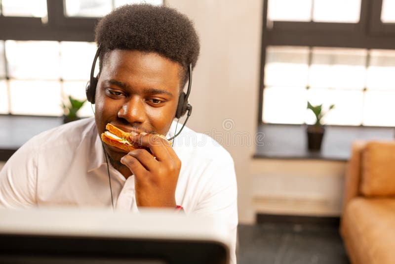 Good looking handsome man having a tasty snack