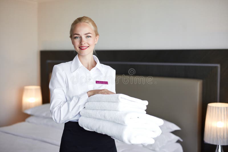 Good Looking Maid With White Linen And Towels In Her Hands