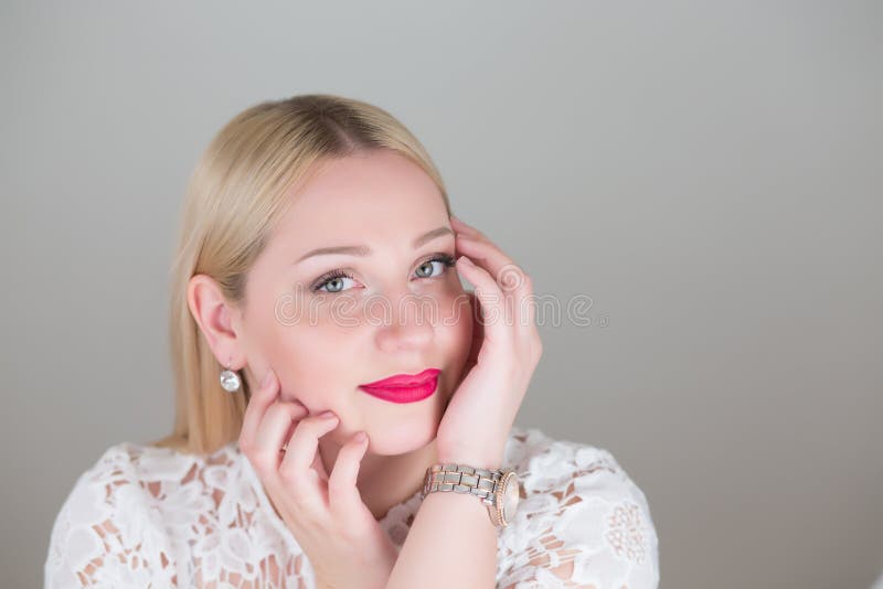 Good-looking portrait blonde woman on gray studio backgounds. stock images Good-looking portrait blonde woman on gray studio backgounds. stock images