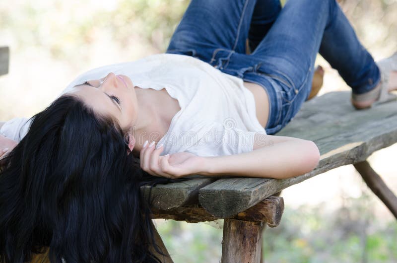 Good looking woman lie on a wooden table