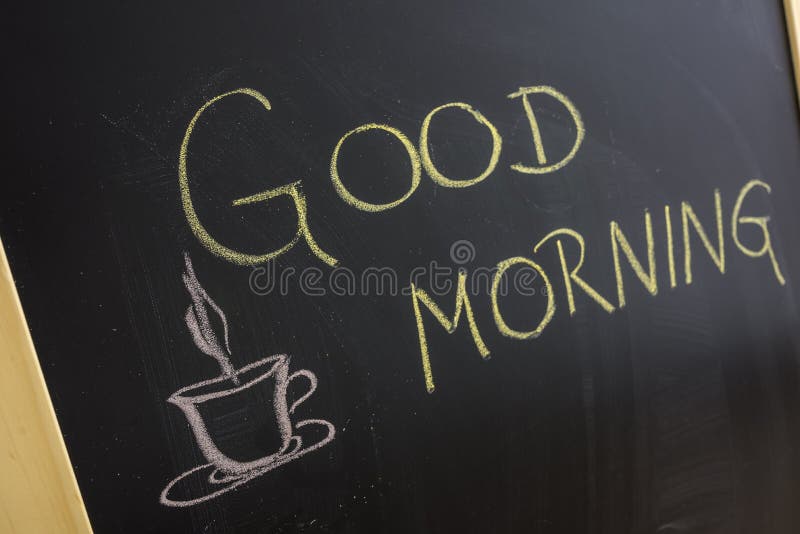 Good morning message with coffee cup written on blackboard.